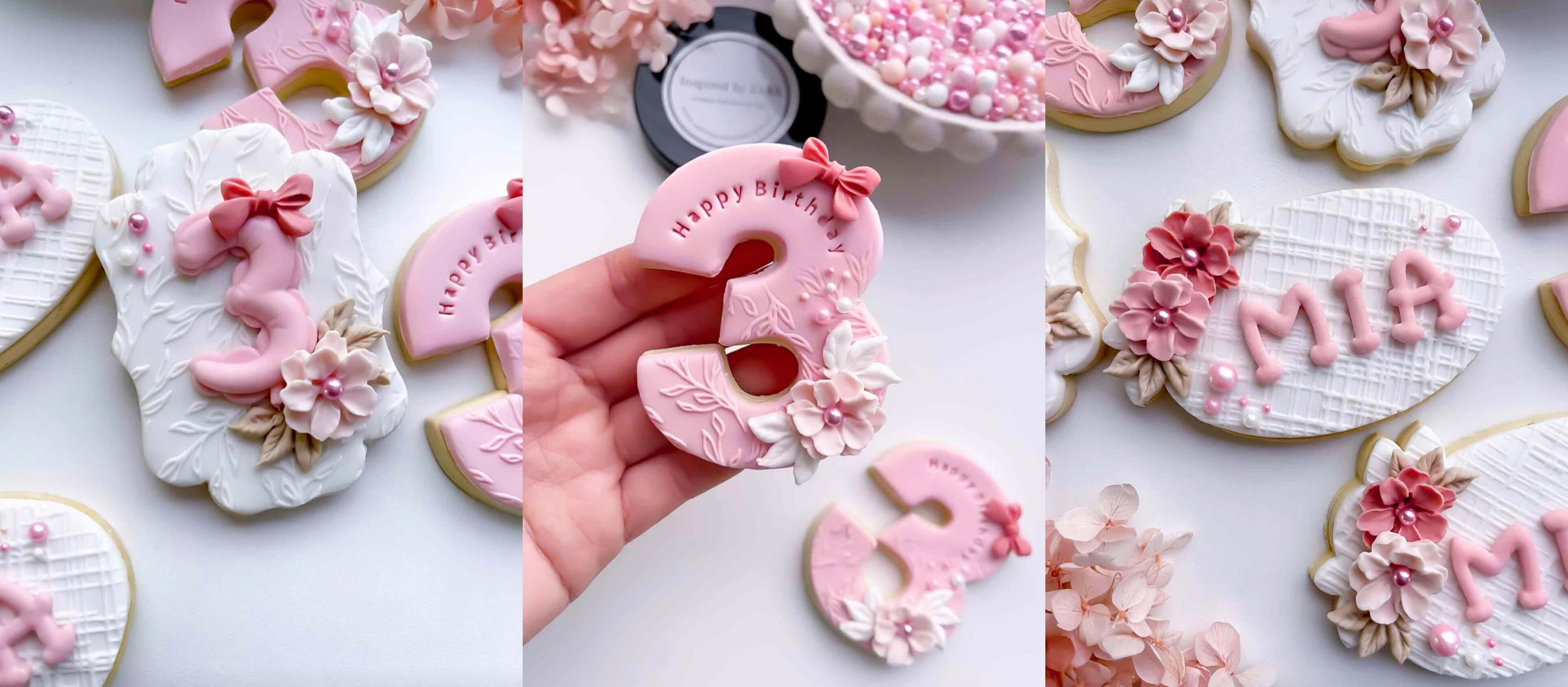 Decorative cookies with floral designs and text on a white surface. Baking Srinkles